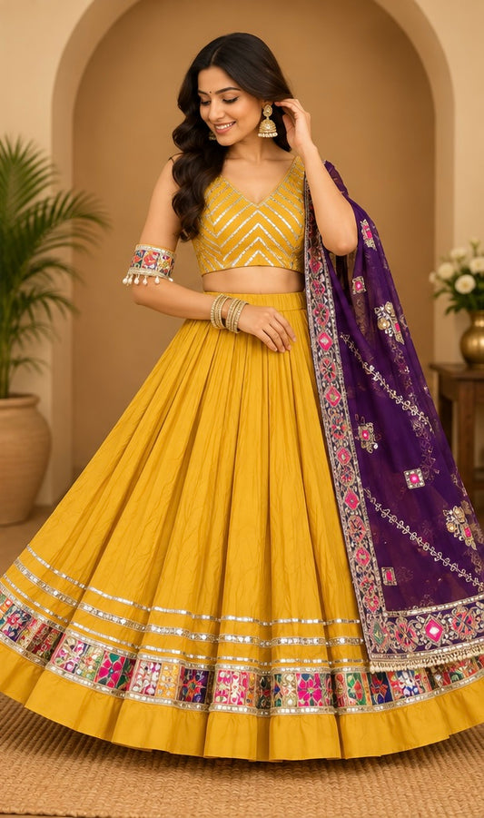 Woman wearing Rangrez mustard yellow and purple Navratri Chaniya Choli